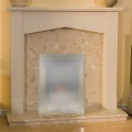 The Tudor Botticino Stone Effect Fireplace